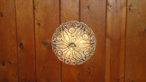 a gold door knocker on a wooden wall at Casa de Tres Lunas/House of Three Moons in Santa Fe