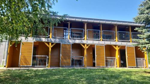 an exterior view of a building with balconies at EL PASO chata C1 - C8 v areáli kúpaliska in Štúrovo