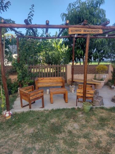a group of benches sitting under a gazebo at Loft 11, caminho do mirante in Iguaba Grande