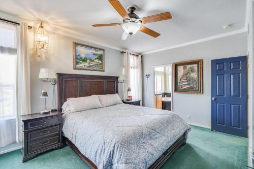 a bedroom with a bed and a ceiling fan at Navigate Stays Pioneertown Retreat w Hot Tub in Pioneertown