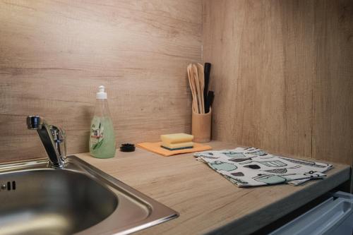 a kitchen counter with a sink and a cutting board at Beach house Lady - resort & tavern BAIN, free transport, pool, Island of Žut - Kornati in Pristanišće
