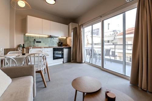 a kitchen and living room with a large window at Preveza Central Stay in Preveza
