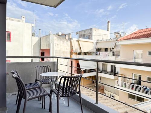 a balcony with two chairs and a table on a building at Preveza Central Stay in Preveza