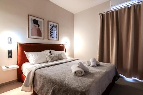 a bedroom with a bed with towels on it at Preveza Central Stay in Preveza