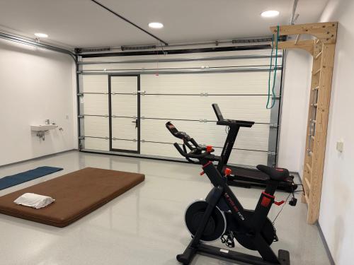 a gym with a treadmill and a exercise bike at Smart & Wellness Villa in Ptuj