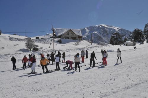 a group of people on skis in the snow at Trikalon Muses Art Suites in Synikia Mesi Trikalon