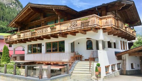 a house with a balcony on top of it at Appartements "Da Zillertaler und die Geigerin" in Mayrhofen
