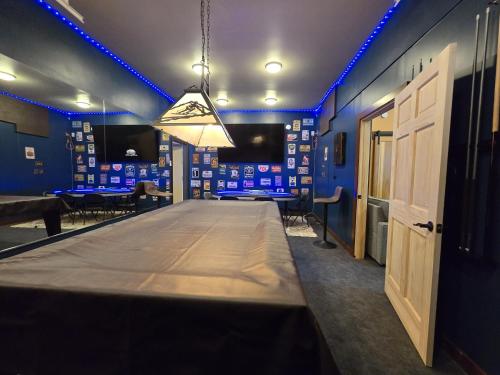 a long table in a room with blue lights at Timberline Tranquility in Girdwood
