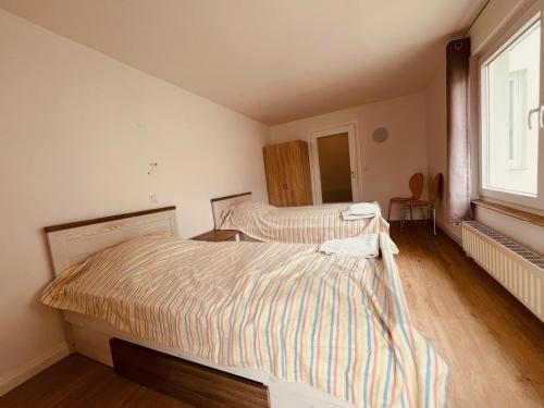 a bedroom with two beds and a window at GR Appartements in Troisdorf