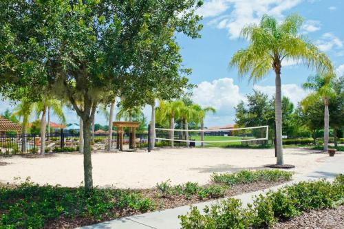 a volleyball court with palm trees in a park at Ground Floor Gathering up to 9 guests BL387 in Kissimmee