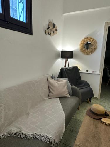a living room with a couch and a chair at Le Rocher 2 in Ermoupoli