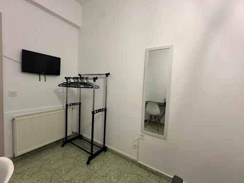 a white room with a television and a mirror at Le Rocher 2 in Ermoupoli