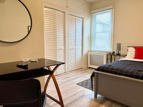 a bedroom with a bed and a desk and a mirror at 2-A Diamond in Yonkers in Yonkers