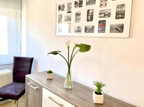 a vase with a plant on a desk in an office at Ferienhaus Jäger in Friedrichshafen