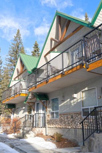 a house with balconies on the side of it at Banff Woods lodge in Canmore