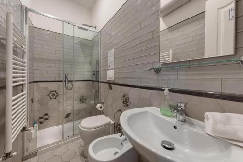 a bathroom with a sink and a toilet at TRIBUNALE 4 LUXURY Rooms - BEDinBOLOGNACENTRO PALACE H in Bologna