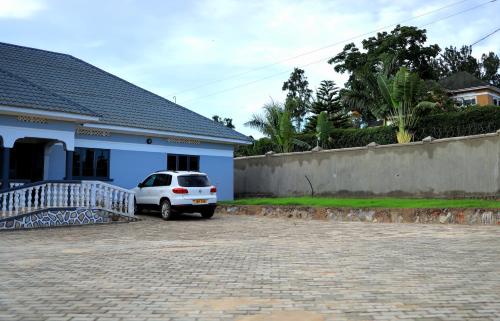 a white car parked in front of a house at ViRRA Suites in Mbarara