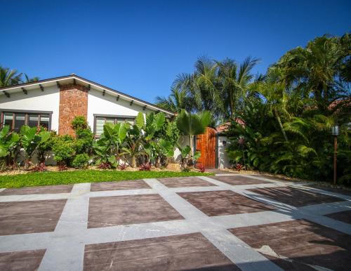 a house with a stone pathway in front of a house at Sunset in Sunset