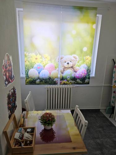 a painting of a teddy bear sitting in a window at Apartman Zlatovo Stan Na Dan in Požarevac