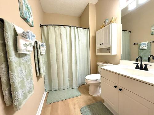 a bathroom with a shower curtain and a toilet at Stay Salty-Newly Renovated-Barefoot Resort, 2 Pools, 2 miles to beach in North Myrtle Beach