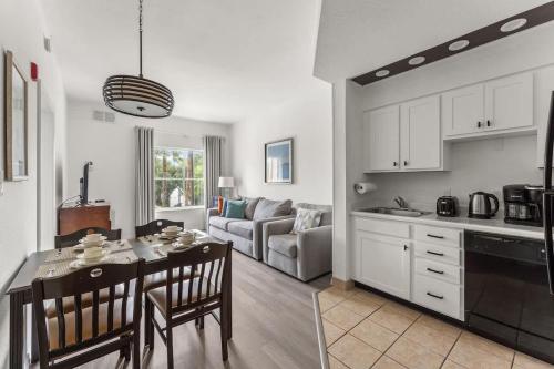 a kitchen and living room with a table and chairs at 1BR FREE Shuttle to Disney Parks HS305 in Orlando