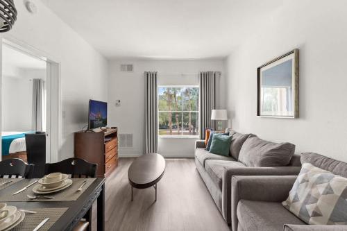 a living room with a couch and a table at 1BR FREE Shuttle to Disney Parks HS305 in Orlando