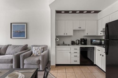 a living room with a couch and a kitchen at 1BR FREE Shuttle to Disney Parks HS305 in Orlando