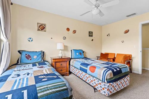 a bedroom with two beds and a table and chairs at Relaxing 3BR Haven for 8 at Seven Dwarfs SD2610 in Kissimmee