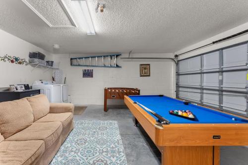 a living room with a pool table and a couch at 4 BR No carpet Just Remodeled Unit SR1205 in Kissimmee