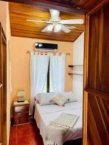 a bedroom with a bed with a ceiling fan at Apartamentos El Labrador in Tamarindo