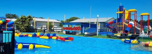 a pool with a water park with a water slide at The Hopeful Hut-Cosy beach vibes-Bring the dog & boat in Kurrimine Beach