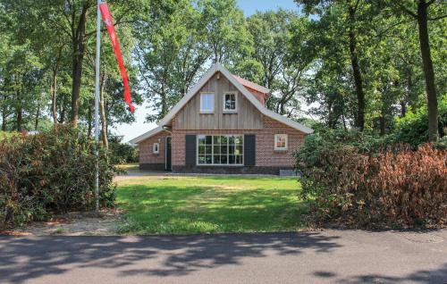 a house with a flag in front of a yard at Three-Bedroom Holiday Home In Hoge Hexel in Hoge-Hexel