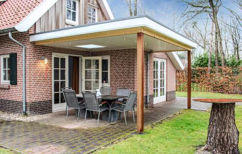 a patio with a table and chairs under a pavilion at Three-Bedroom Holiday Home In Hoge Hexel in Hoge-Hexel
