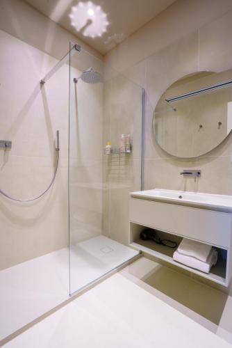 a bathroom with a glass shower and a sink at La Vista Panoramica in Riomaggiore