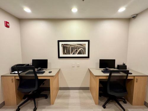 an office with two desks with two computers on them at Country Inn & Suites by Radisson, Port Charlotte, FL in Port Charlotte