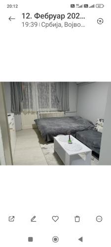 a room with a bed and a coffee table at Lenka 2 in Sremska Mitrovica