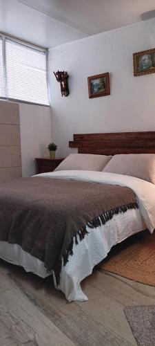 a bedroom with a large bed and a window at La casa de huespedes in Puebla de Vallbona