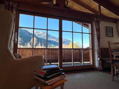 a room with a large window and a pile of books at Chalet Aurach in Aurach bei Kitzbuhel