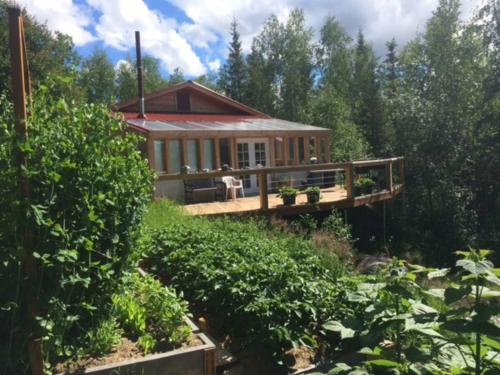 a house in the middle of a garden at Moose Mountain Cabin- Cozy retreat with aurora views in Fairbanks