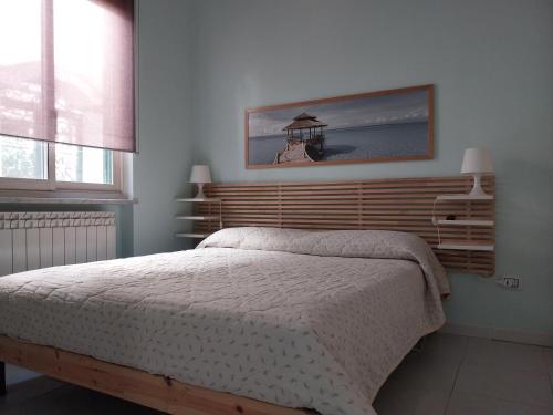 a bedroom with a bed with a wooden headboard at Turchese in Amalfi