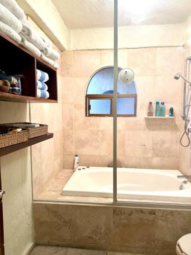 a bathroom with a tub and a window at Penthouse Vallarta in Puerto Vallarta