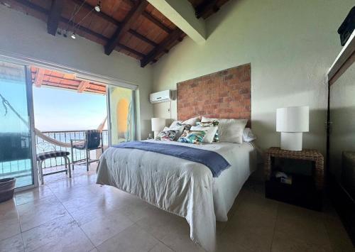 a bedroom with a large bed and a balcony at Penthouse Vallarta in Puerto Vallarta