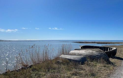 two boats sitting on the side of a body of water at Stunning Home In Gotland With Kitchen in Gnisvärd