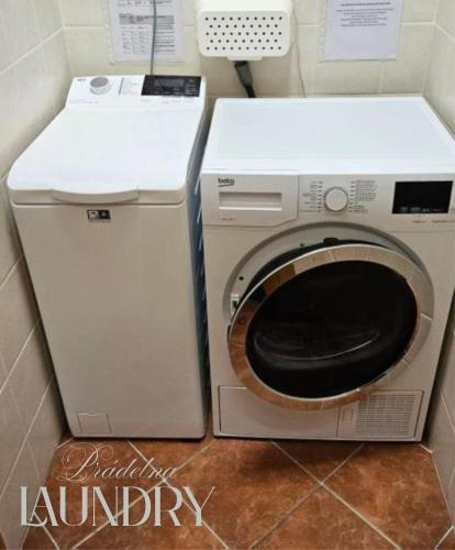 a washer and dryer in a small room at Hotel Claris in Prague