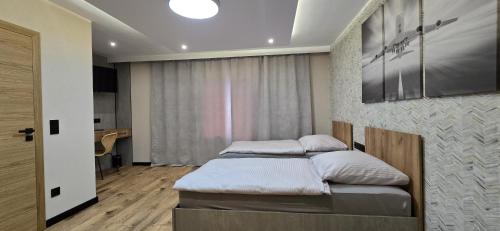 a bedroom with two beds and a painting on the wall at KaMi Self check-in 24 h in Głogówek
