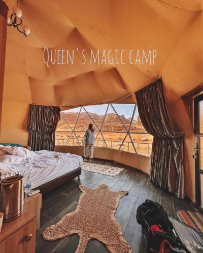 a woman standing in a bedroom with a tent at Queen's Magic Camp in Wadi Rum