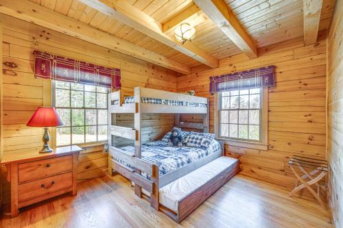 a bedroom with a bunk bed in a log cabin at 9 Mi to Bretton Woods Carroll Log Cabin with Deck in Carroll