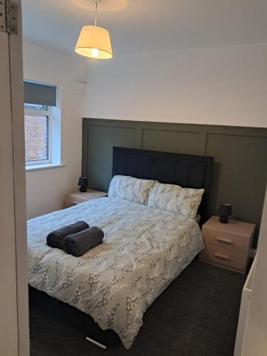 a bedroom with a large bed with a black headboard at Rembrandt House Norton in Stockton-on-Tees