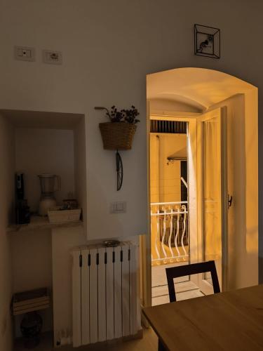 a dining room with a table and a door to a balcony at Adalù apartments in Conversano