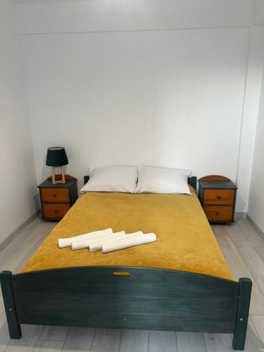 a bed with two white objects on top of it at MC Apartamenty Ściegiennego 3 in Augustów